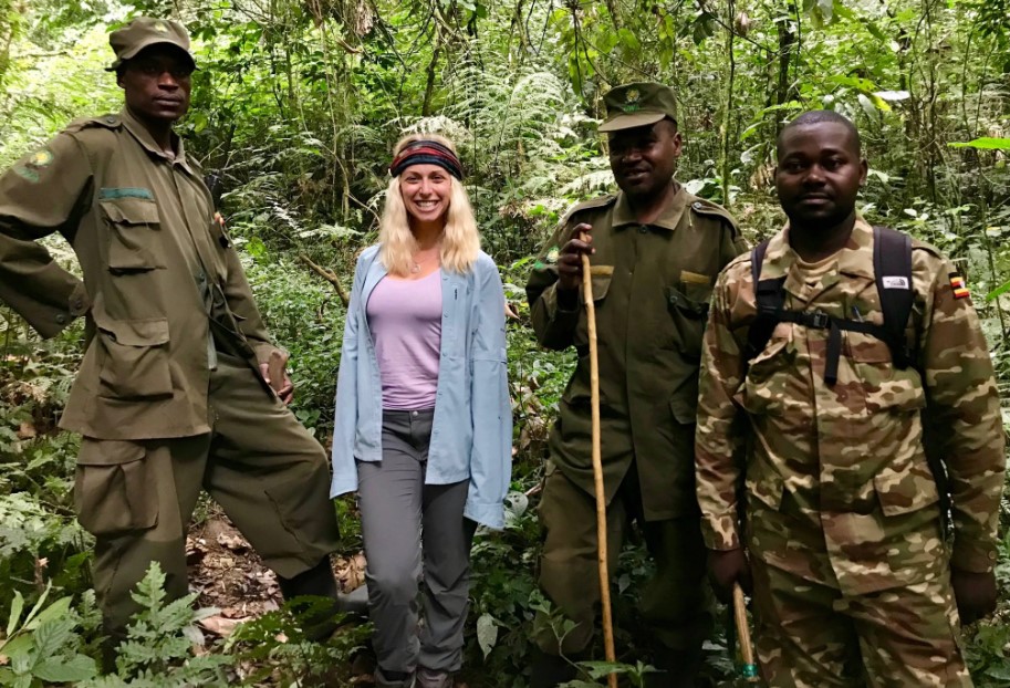 A tourist guided by rangers in Bwindi